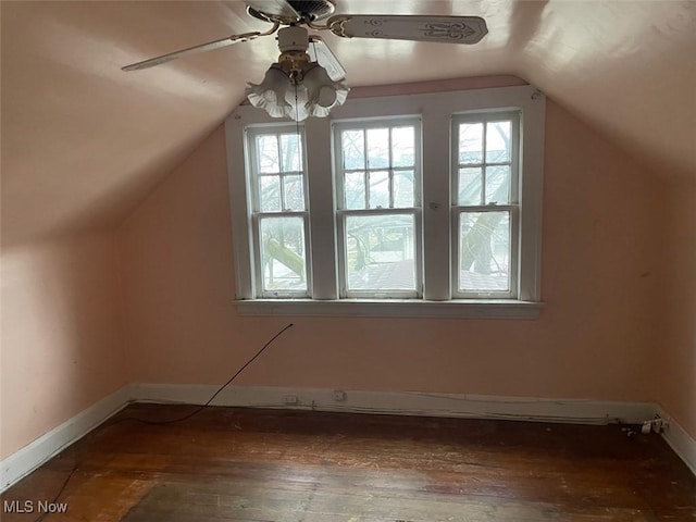 bonus room featuring lofted ceiling, dark wood-type flooring, ceiling fan, and plenty of natural light