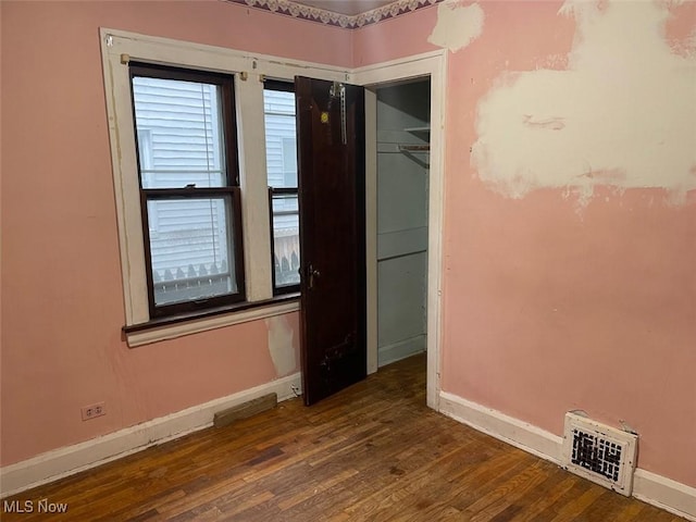 unfurnished room with wood-type flooring