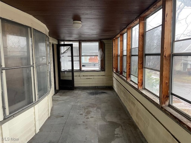 unfurnished sunroom featuring wood ceiling