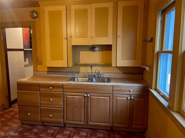 kitchen with sink and dark parquet flooring