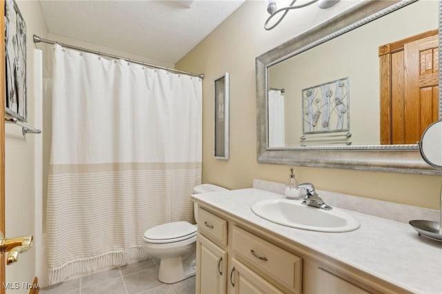 bathroom with vanity, tile patterned floors, and toilet