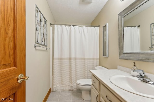 bathroom with toilet, a textured ceiling, vanity, curtained shower, and tile patterned flooring