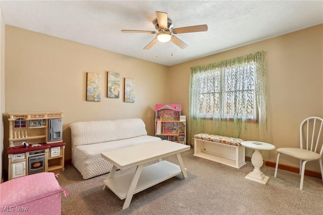 interior space with ceiling fan, carpet, and a textured ceiling