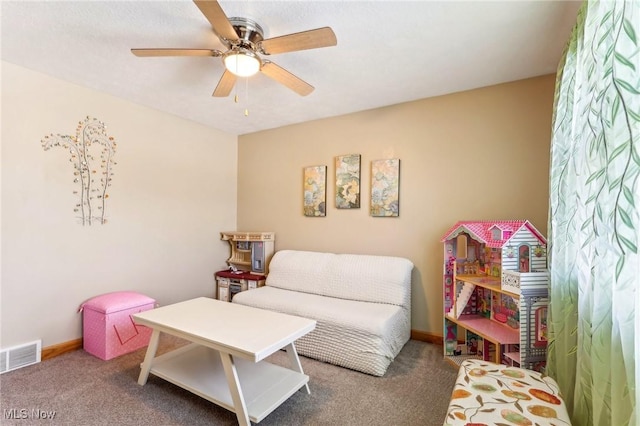 recreation room with ceiling fan and carpet