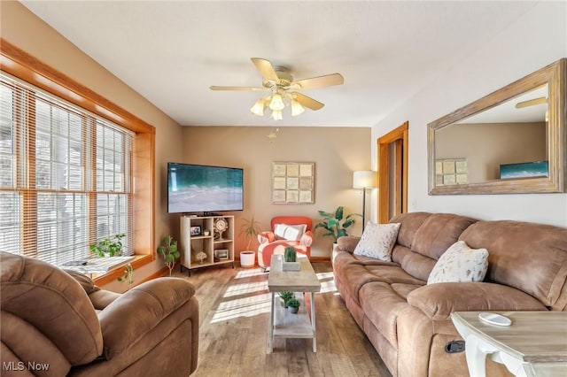 living room featuring hardwood / wood-style flooring and ceiling fan