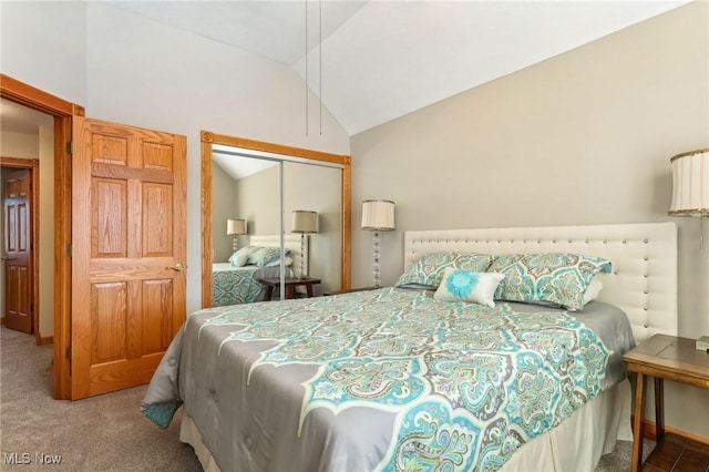 carpeted bedroom featuring vaulted ceiling and a closet