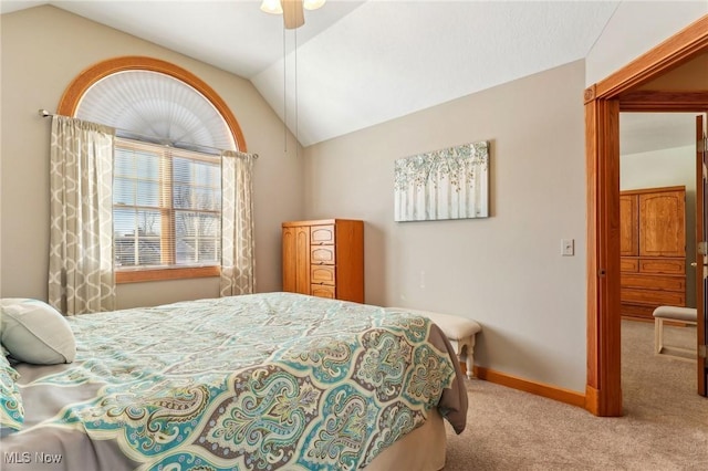 carpeted bedroom featuring vaulted ceiling and ceiling fan