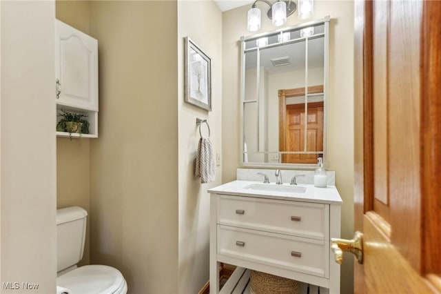 bathroom featuring vanity and toilet