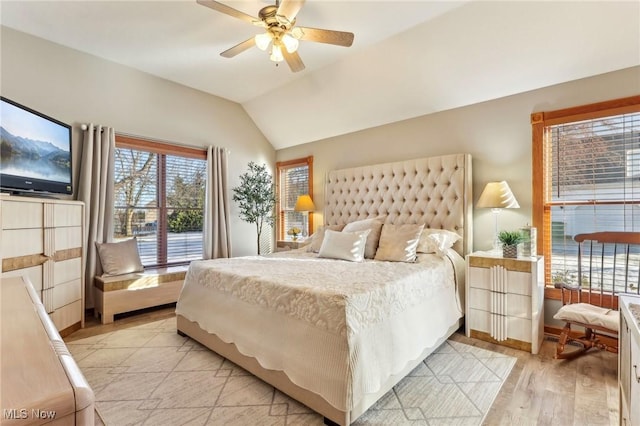 bedroom featuring ceiling fan, vaulted ceiling, and light hardwood / wood-style flooring