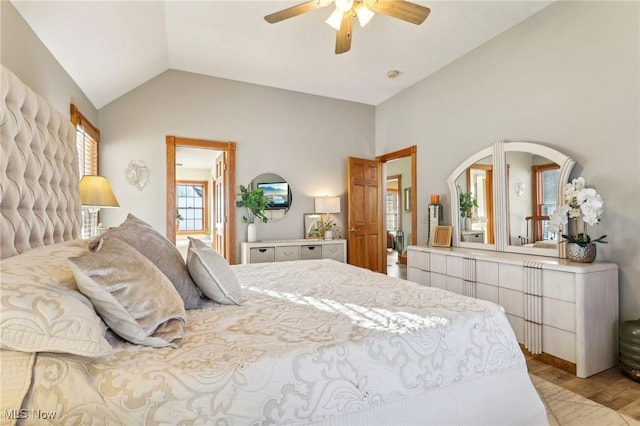 bedroom featuring lofted ceiling, light hardwood / wood-style flooring, and ceiling fan