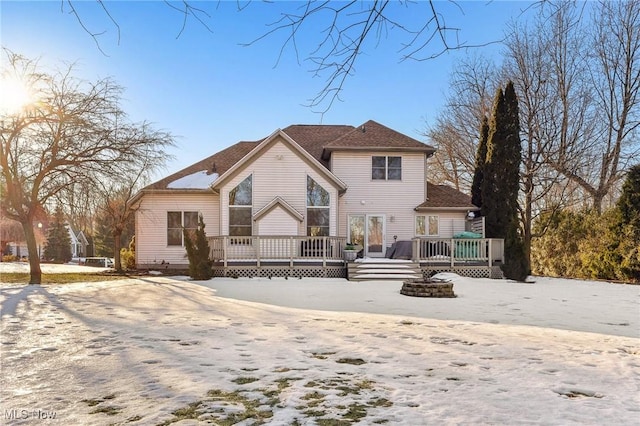 snow covered property featuring a deck