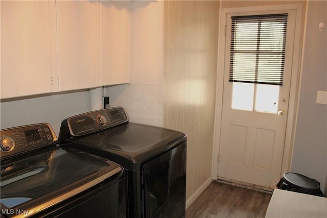 laundry area with cabinets, dark hardwood / wood-style floors, and washer and dryer