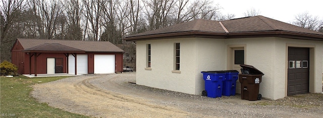 view of side of home with an outbuilding and a garage