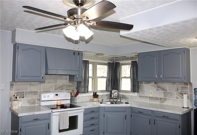 kitchen featuring wall chimney exhaust hood, sink, tasteful backsplash, a textured ceiling, and electric stove