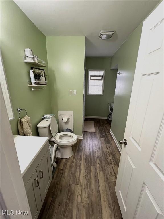 bathroom with vanity, hardwood / wood-style floors, and toilet