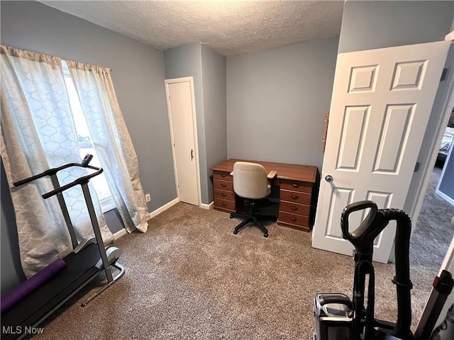 carpeted home office with a textured ceiling