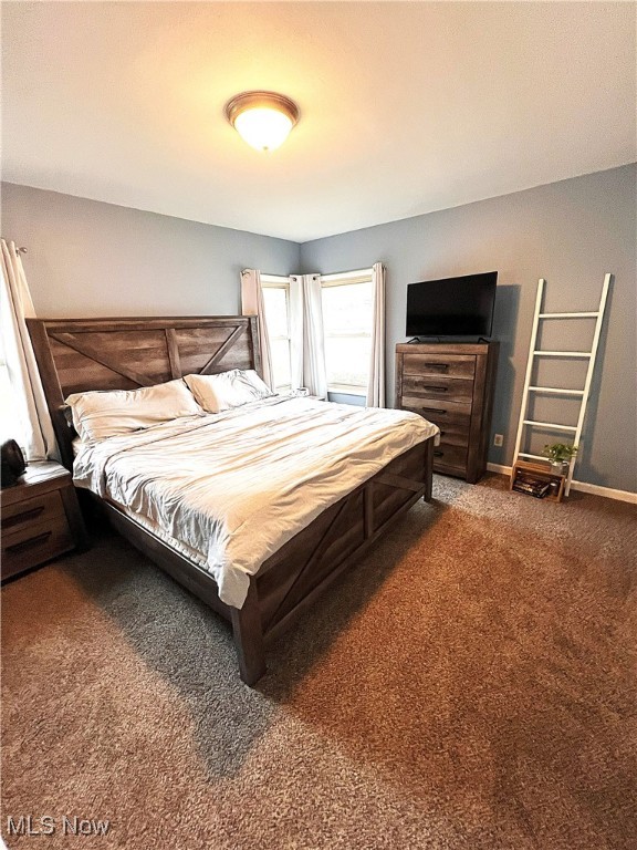 bedroom featuring dark colored carpet