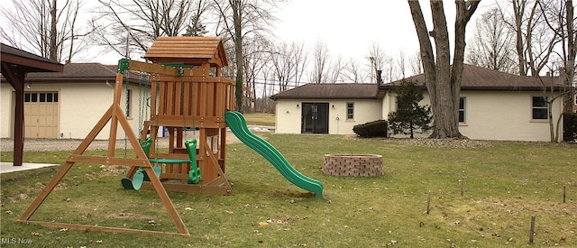 view of playground featuring a yard and a fire pit