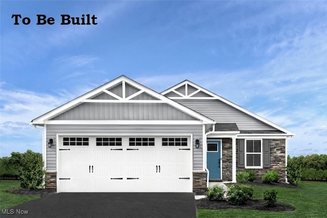 craftsman-style house with a garage and a front lawn