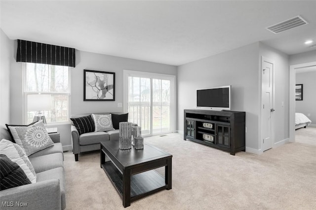 carpeted living room with plenty of natural light