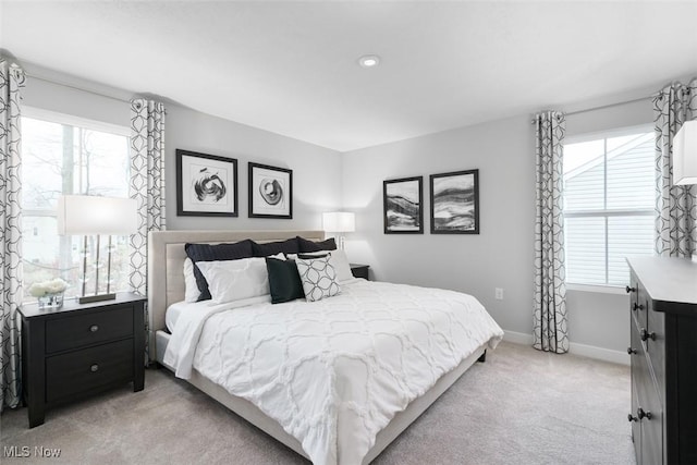 carpeted bedroom featuring multiple windows