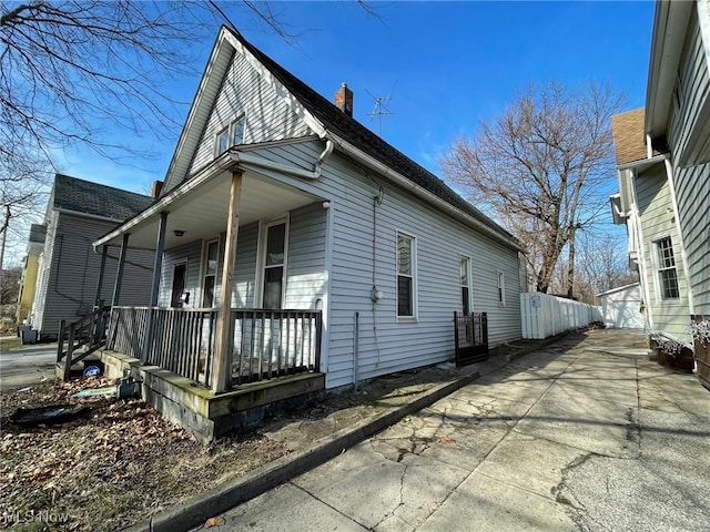 view of side of property with a porch