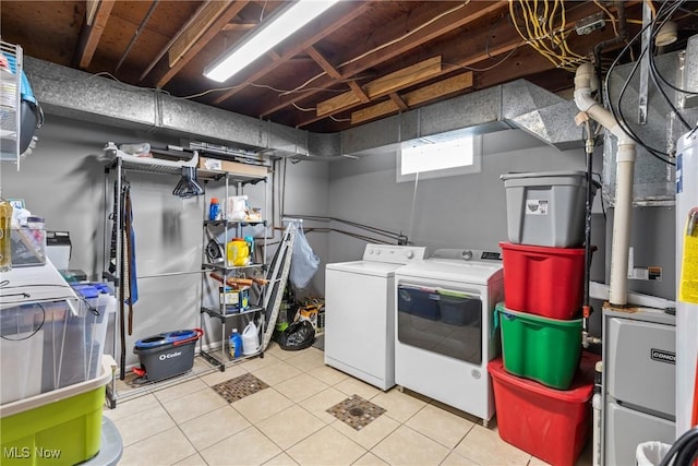 laundry area featuring light tile patterned floors and washing machine and clothes dryer