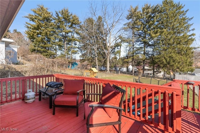 wooden deck featuring a yard