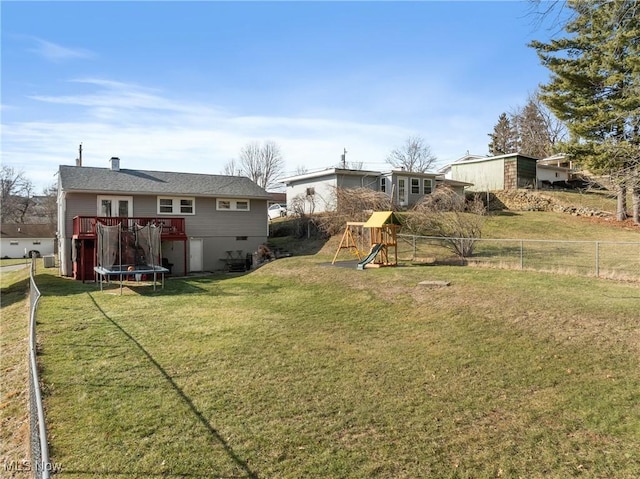 view of yard featuring a playground and a trampoline