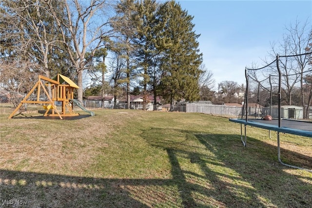 view of yard featuring a trampoline and a playground