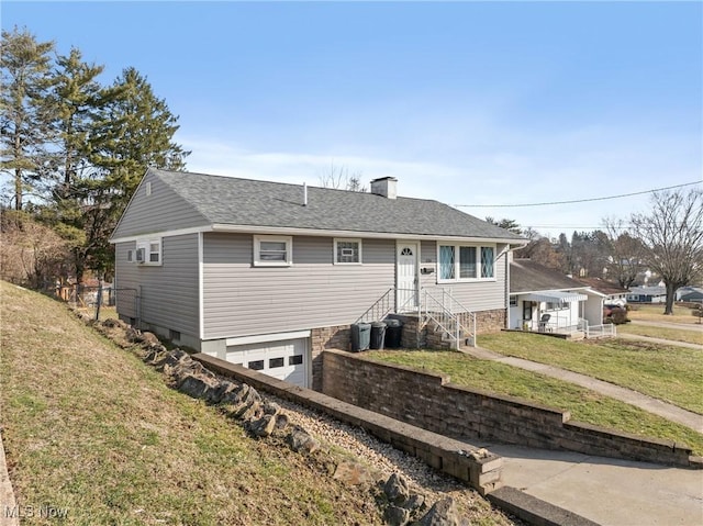 view of front of property with a garage and a front yard