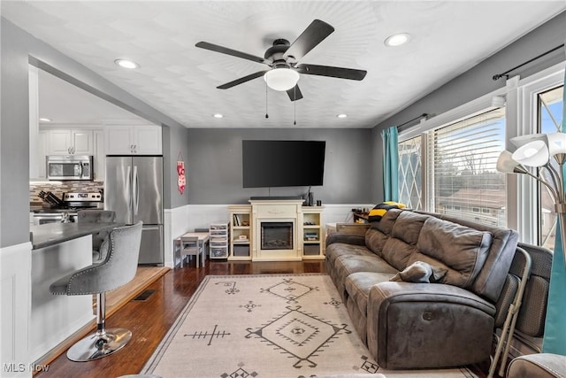 living room featuring dark hardwood / wood-style floors and ceiling fan