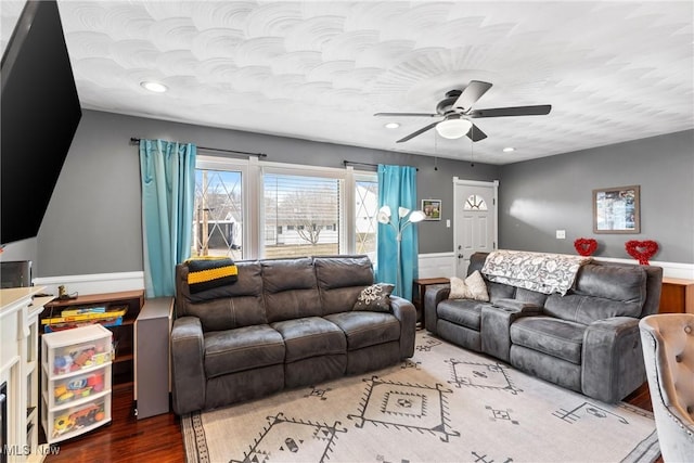 living room with wood-type flooring and ceiling fan