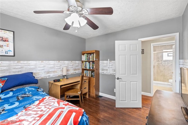 bedroom with connected bathroom, ceiling fan, dark wood-type flooring, and a textured ceiling