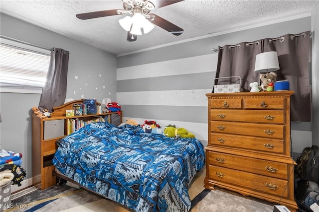 bedroom featuring ceiling fan, light colored carpet, and a textured ceiling