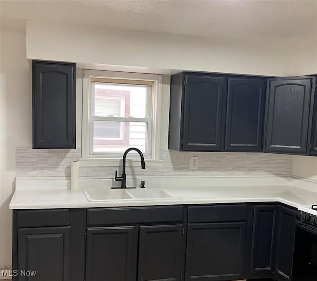 kitchen with stove, sink, and backsplash