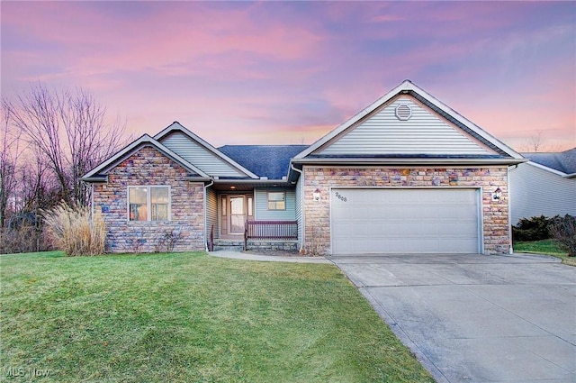 view of front of property with a garage and a lawn