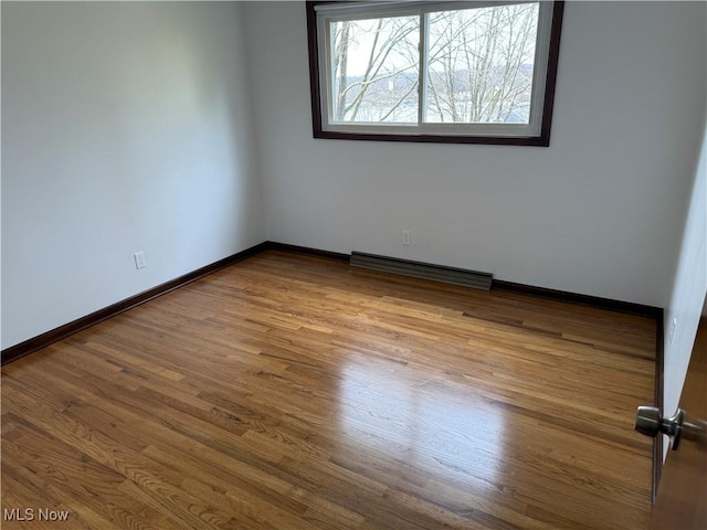 unfurnished room with hardwood / wood-style floors