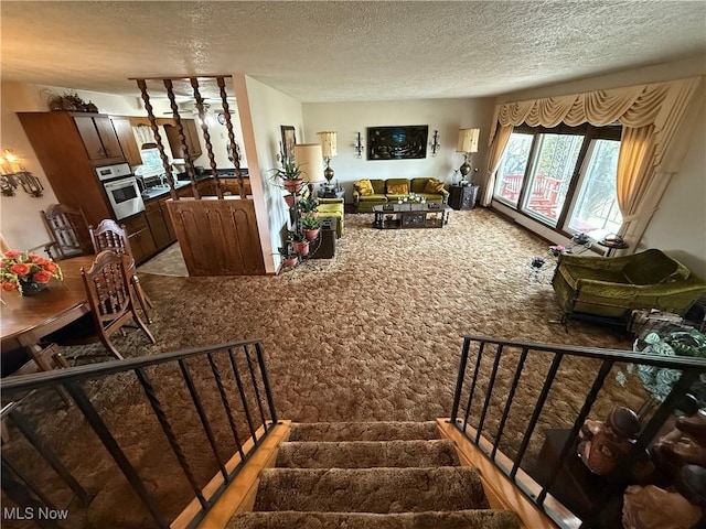 interior space with carpet floors and a textured ceiling