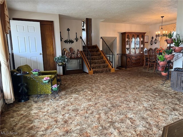 interior space featuring an inviting chandelier, a textured ceiling, and carpet