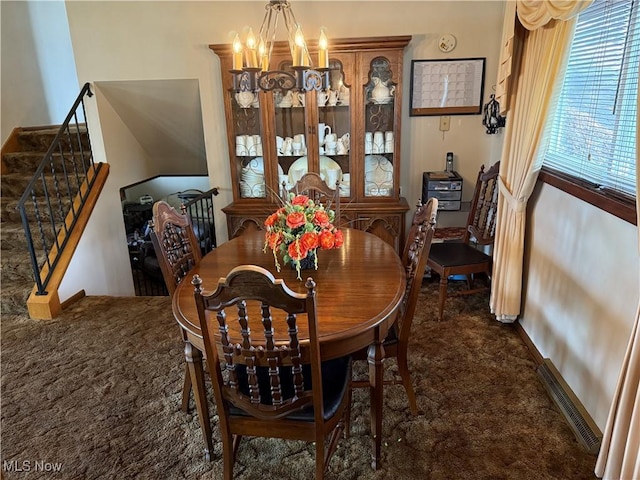 dining room with an inviting chandelier and dark carpet