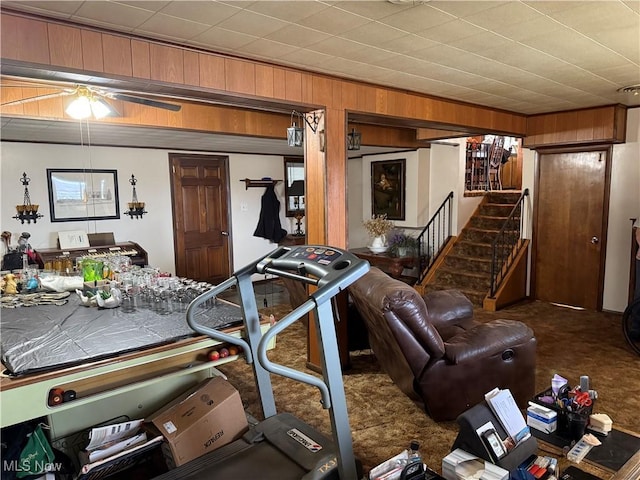 interior space featuring carpet floors and wooden walls