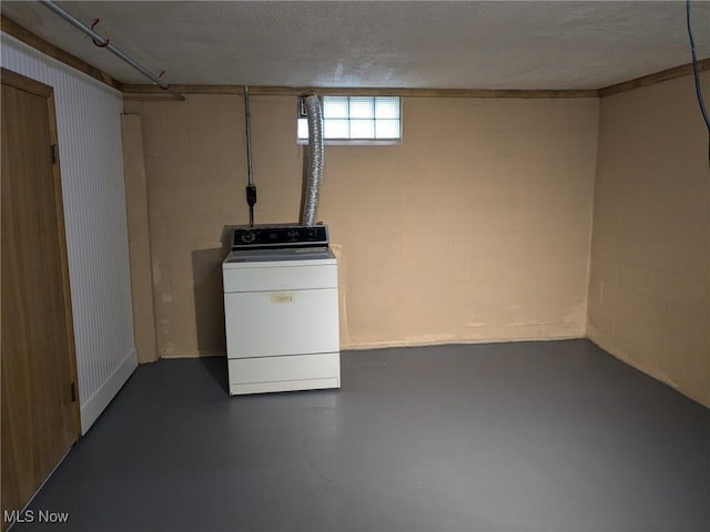 basement with washer / clothes dryer and a textured ceiling