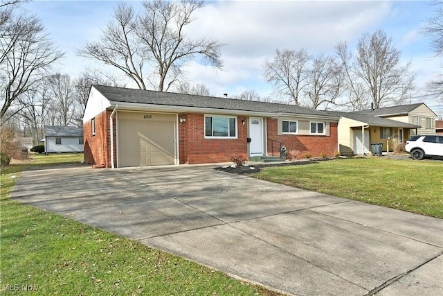 single story home with a garage and a front lawn