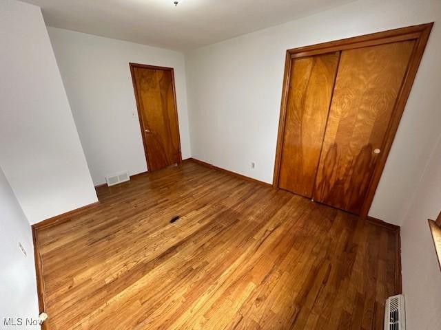 unfurnished bedroom with wood-type flooring