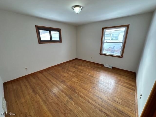 unfurnished room featuring wood-type flooring