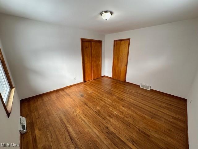 unfurnished room featuring hardwood / wood-style flooring