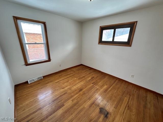 unfurnished room featuring light wood-type flooring