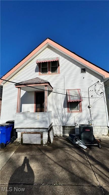 rear view of house featuring a patio and cooling unit