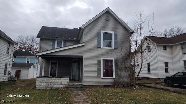 front of property featuring a front yard and covered porch